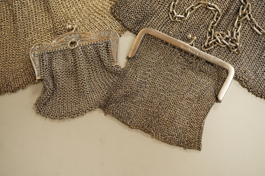 A George V silver mesh evening bag, import marks for Paul Ettlinger, London, 1932, a similar small evening purse, import marks for London, 1919 and two other white metal mesh evening bags or purses, one stamped sterling.